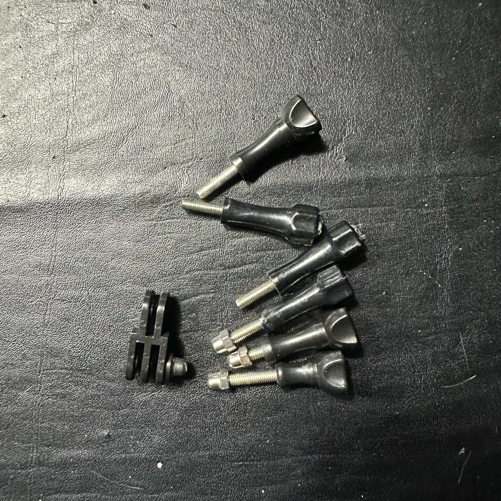 Bundle of Go Pro Head Mount, 3 Stick Mounts , Clip, Charger and Thumbscrews